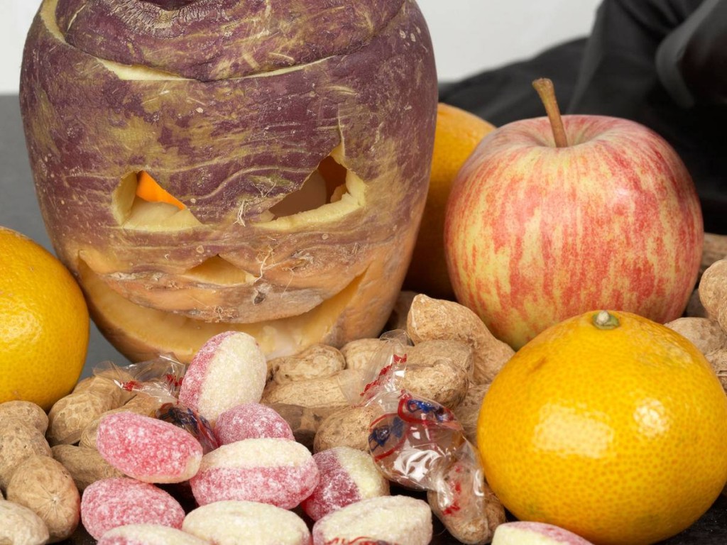 BT846X the spoils from trick or treating with halloween turnip jack-o-lantern. Traditionally in Ireland turnips or swedes were used